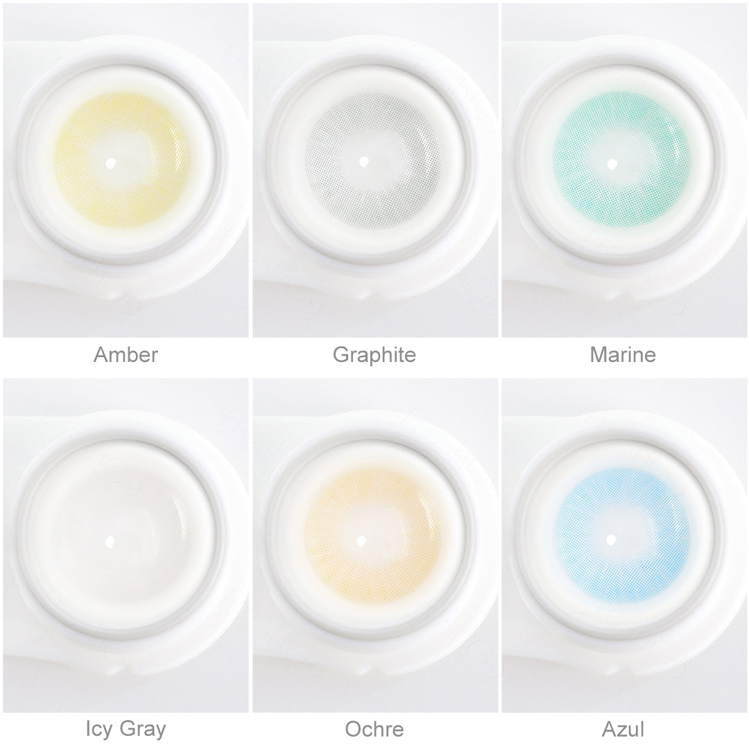 Array of Hidrocor contact lenses in a white case, showcasing six colors: Amber, Graphite, Marine, Icy Gray, Ochre, and Azul. Each lens is labeled with its color name beneath the case.