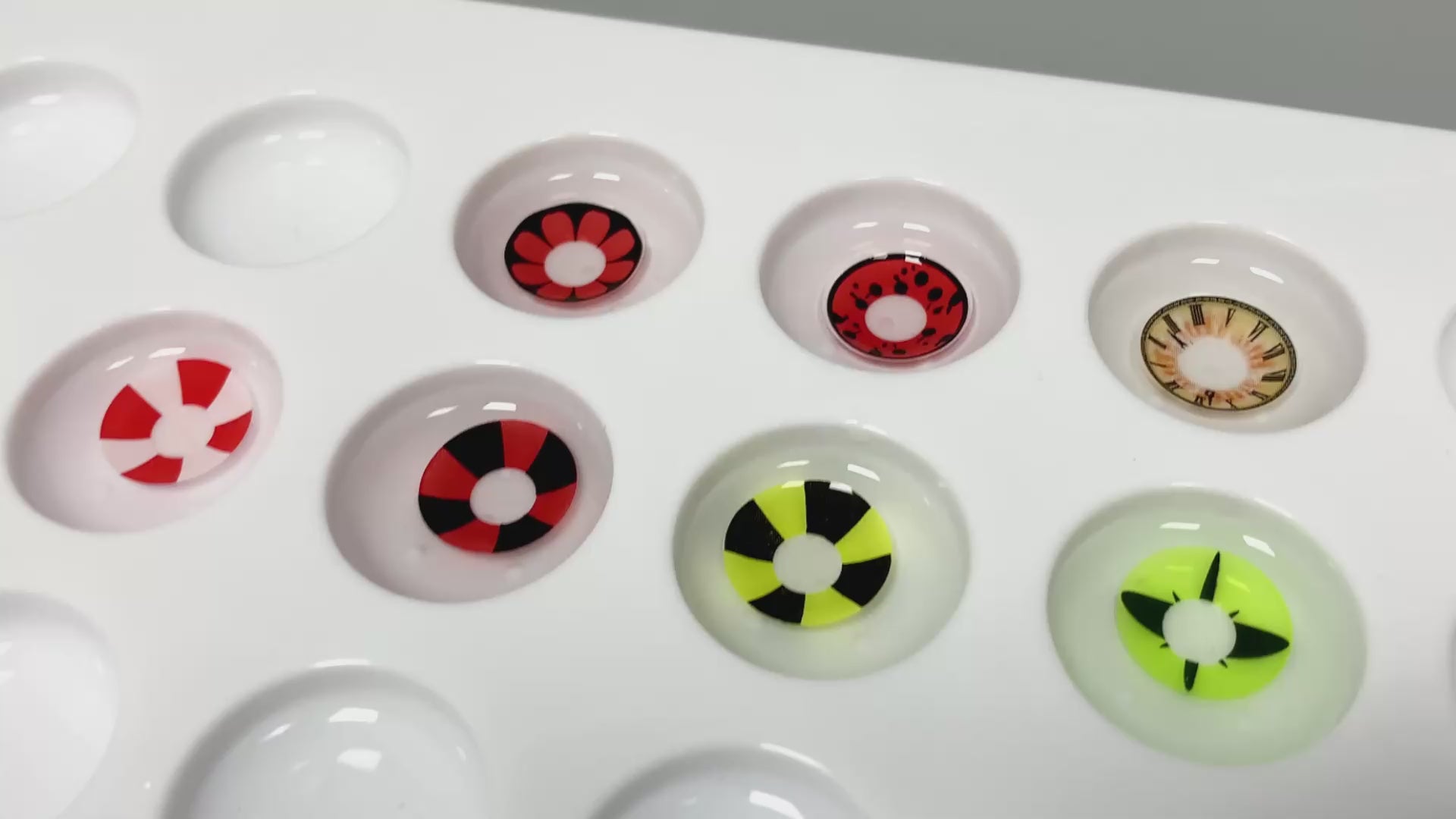 Product video presenting a range of cosplay contact lenses, featuring close-up views of the lenses in various shades and demonstrating how they appear when applied to the eyes.