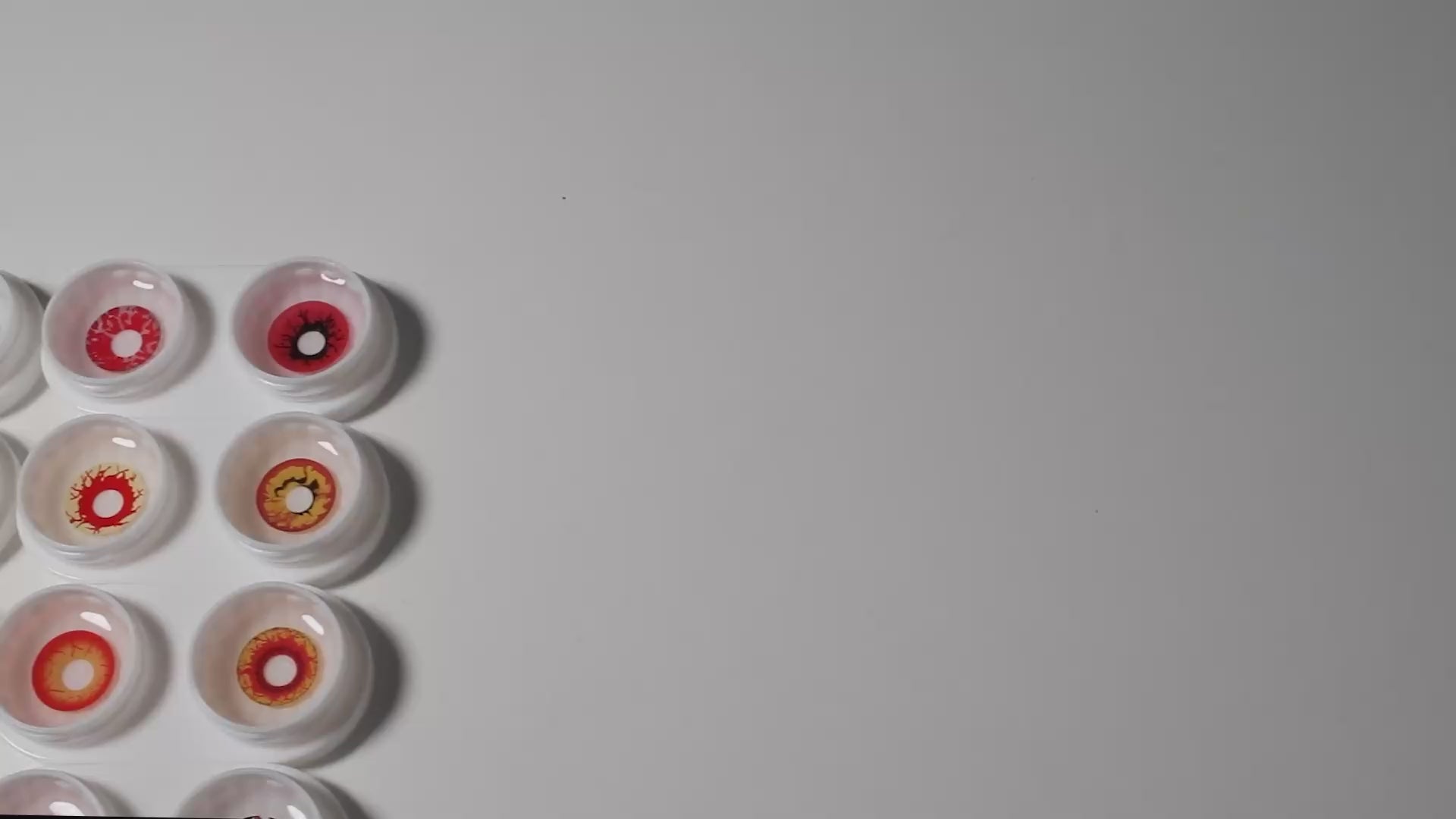 Product video presenting a range of Cosplay Zombie Costume Contacts, featuring close-up views of the lenses in various shades and demonstrating how they appear when applied to the eyes.