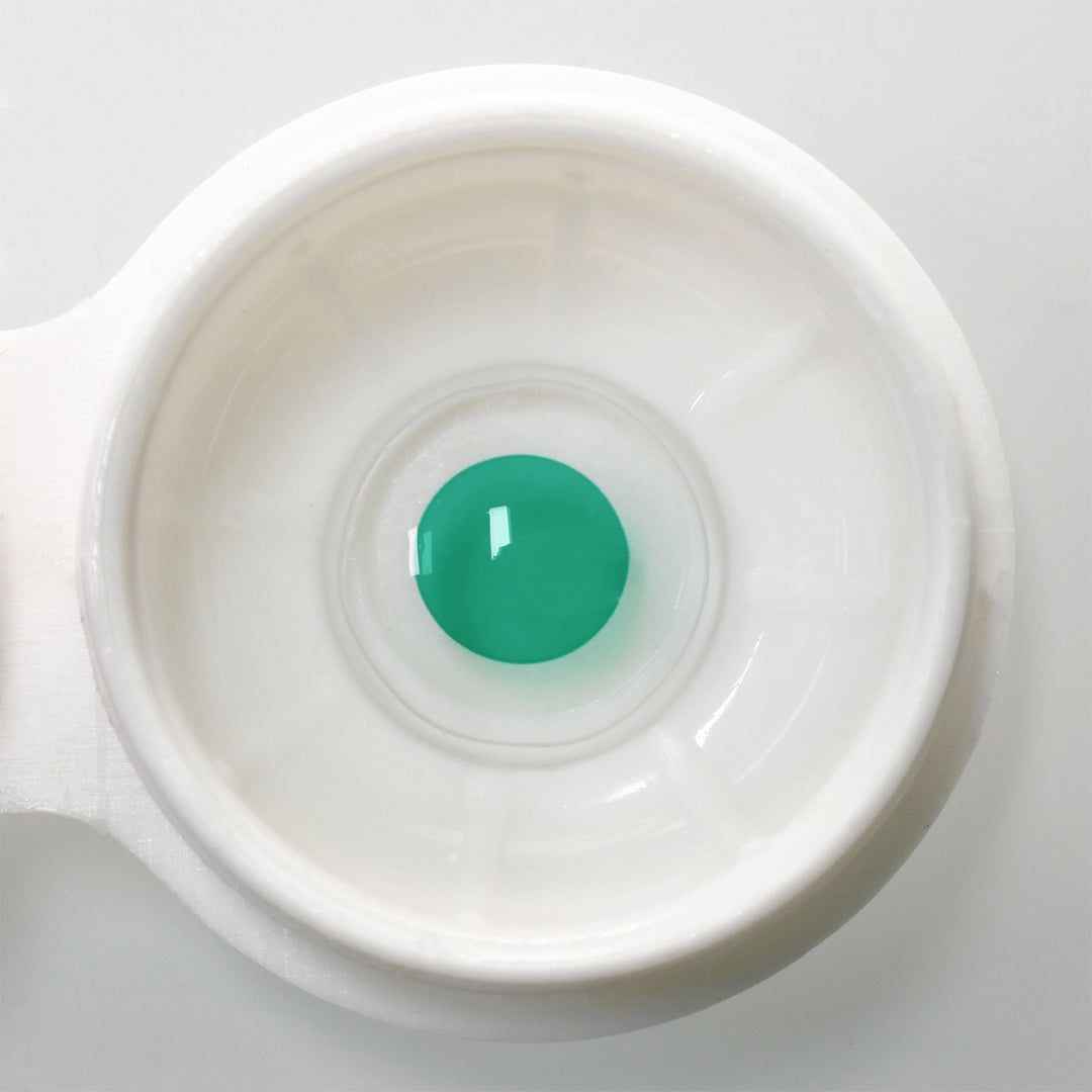 Color Blind Lens- F5 Green, showed in a white case.