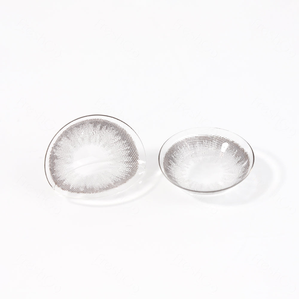 2 pcs lenses of DIAMOND contact lenses on a white surface, showing the details of the lens pattern from the front and back