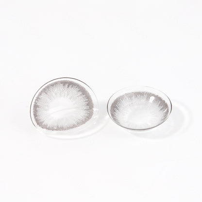 2 pcs lenses of DIAMOND contact lenses on a white surface, showing the details of the lens pattern from the front and back
