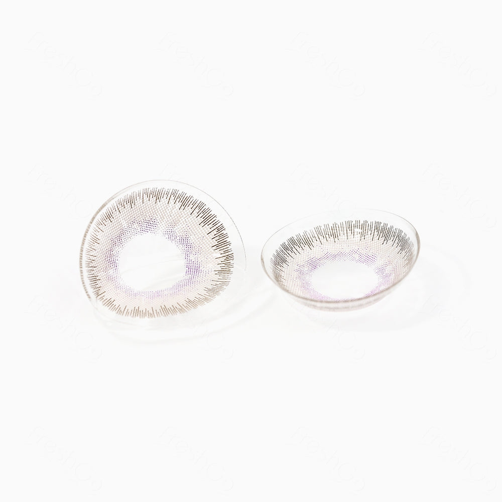 2 pcs lenses of ELITE contact lenses on a white surface, showing the details of the lens pattern from the front and back