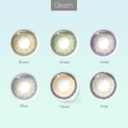 Grid layout of Gleam colored contact lenses in various shades with each lens' color name: Brown, Green, Violet, Blue, Hazel and Gray, on a soft gradient background.