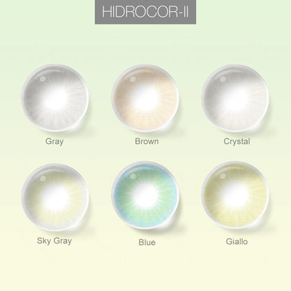 Grid layout of HIDROCOR_II colored contact lenses in various shades with each lens' color name:A brown-eyes model showcasing HIDROCOR_II natural colored contact lenses, display the eyes effect of Gray,Crystal,Brown,Sky Gray,Blue,Giallo with close-up insets highlighting the natural and enhanced eye colors available., on a soft gradient background.