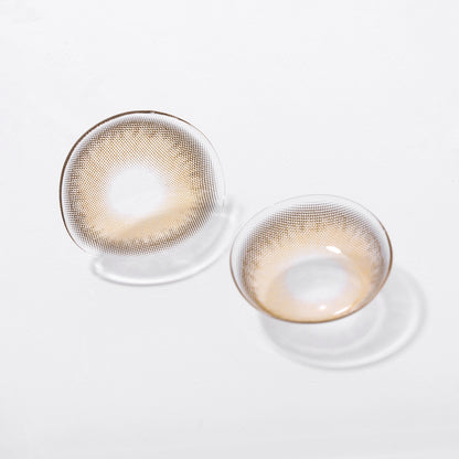 Two lenses of Russo contact lenses on a white surface, showing the details of the lens pattern from the front and back