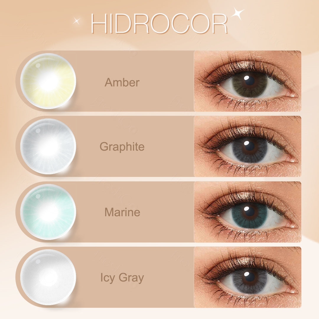 A display of Hidrocor colored contacts in Amber, Graphite, Marine, and Icy Gray, each shown both as a lens swatch and worn in a close-up of a model's eye, with the color names labeled beneath each image.