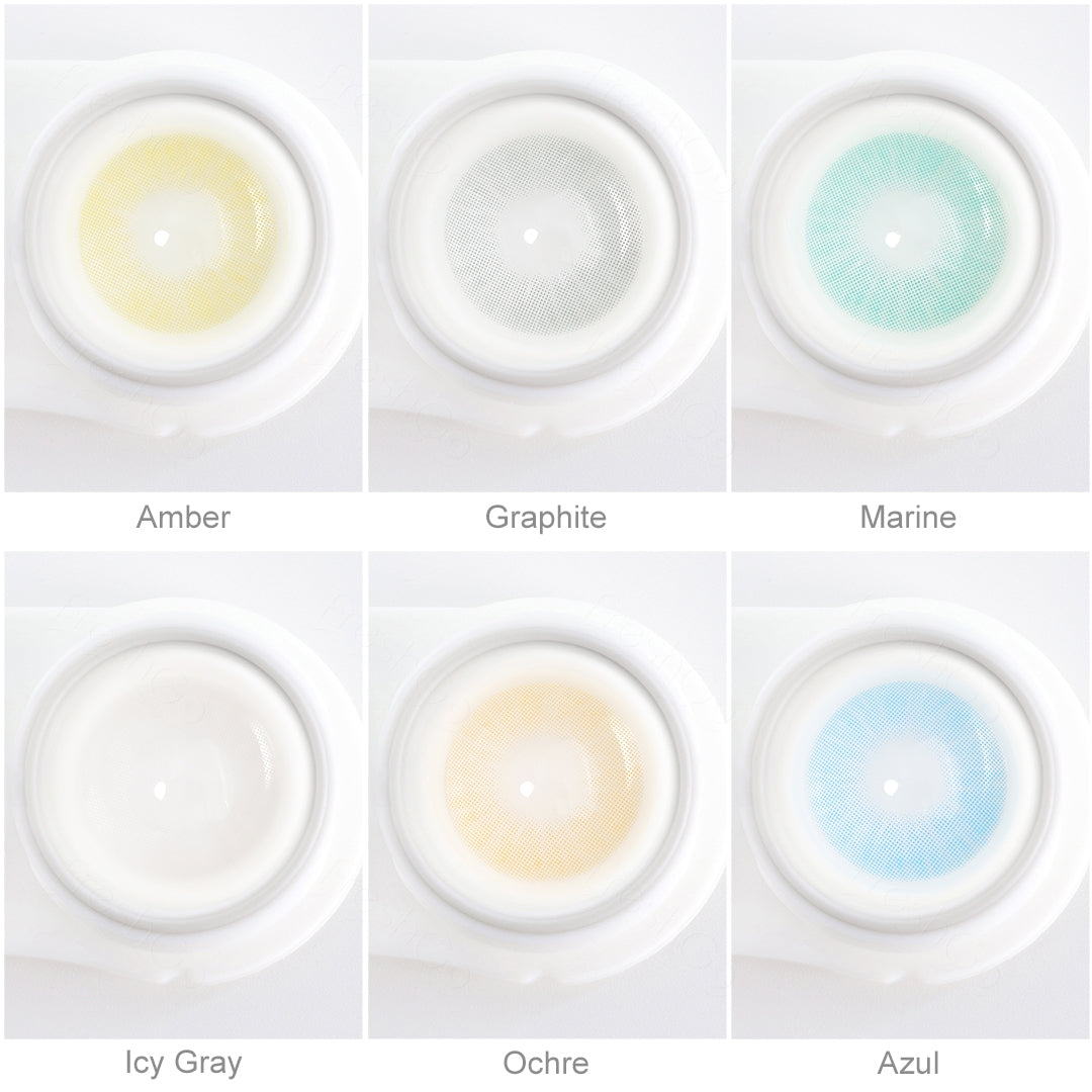 Array of Hidrocor contact lenses in a white case, showcasing six colors: Amber, Graphite, Marine, Icy Gray, Ochre, and Azul. Each lens is labeled with its color name beneath the case.